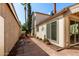 Enclosed backyard with brick patio, mature trees, and unique desert landscaping features at 448 E Wescott Dr, Phoenix, AZ 85024