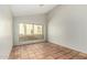 Bright, naturally lit bedroom with neutral walls, terra cotta flooring, and a large window with a view of desert plants at 448 E Wescott Dr, Phoenix, AZ 85024