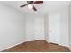 Bedroom with ceiling fan, wood floors, and ample closet space at 448 E Wescott Dr, Phoenix, AZ 85024