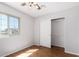 Cozy bedroom featuring wood floors, natural light, and a spacious closet at 448 E Wescott Dr, Phoenix, AZ 85024