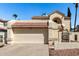 View of two-car garage, tiled roof, rock landscaping and secured gate entrance at 448 E Wescott Dr, Phoenix, AZ 85024