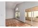 Living room featuring tile floors, vaulted ceiling and sliding glass doors to patio at 448 E Wescott Dr, Phoenix, AZ 85024