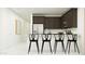 Stylish kitchen featuring dark cabinetry and an island with seating for four at 4646 E French Rd, San Tan Valley, AZ 85143
