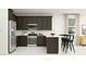 Modern kitchen with stainless steel appliances and a breakfast bar for casual dining at 4646 E French Rd, San Tan Valley, AZ 85143