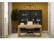 A bright office features a wooden desk, modern decor and ample natural light, creating an ideal and productive workspace at 4646 E French Rd, San Tan Valley, AZ 85143