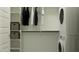 Walk-in closet equipped with shelving, hanging space, and in-unit washer and dryer to maximize storage and efficiency at 4646 E French Rd, San Tan Valley, AZ 85143