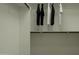 A clean walk-in closet is equipped with shelves and hanging rods for optimal clothing and storage organization at 4646 E French Rd, San Tan Valley, AZ 85143