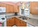 Functional kitchen with stainless steel sink and view to the front yard at 4729 E Dolphin Ave, Mesa, AZ 85206