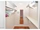 Spacious walk-in closet with ample shelving and a well-lit interior at 4729 E Dolphin Ave, Mesa, AZ 85206