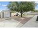 Spacious backyard featuring mature trees, a playground, a shed, and a grassy area at 4938 W Tuckey Ln, Glendale, AZ 85301