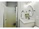 Bathroom featuring a walk-in shower with frameless glass and a modern white vanity at 4938 W Tuckey Ln, Glendale, AZ 85301