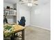 Bright bedroom with a wooden desk, gaming chair, ceiling fan, and closet at 4938 W Tuckey Ln, Glendale, AZ 85301