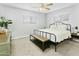 Neutral bedroom with a black metal bed frame, bench, and large windows providing natural light at 4938 W Tuckey Ln, Glendale, AZ 85301