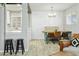 Open-concept kitchen and dining area with bar stool seating, ample lighting, and stylish decor at 4938 W Tuckey Ln, Glendale, AZ 85301