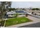 Charming single-story home featuring solar panels, a well-manicured lawn, and a long driveway at 4938 W Tuckey Ln, Glendale, AZ 85301