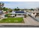Charming home featuring solar panels, a well-manicured lawn, and a covered carport at 4938 W Tuckey Ln, Glendale, AZ 85301
