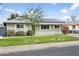 Updated single-story home featuring solar panels, freshly cut lawn, and mature landscaping at 4938 W Tuckey Ln, Glendale, AZ 85301