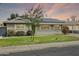 Charming single-story home featuring a well-manicured lawn, solar panels, and lovely curb appeal at 4938 W Tuckey Ln, Glendale, AZ 85301
