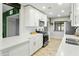 Modern kitchen boasts stainless steel appliances, white cabinets, and stylish tile flooring at 4938 W Tuckey Ln, Glendale, AZ 85301