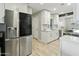 Updated kitchen featuring stainless steel fridge and fixtures, complemented by white cabinetry at 4938 W Tuckey Ln, Glendale, AZ 85301