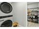 A convenient laundry room features a stacked washer and dryer and a spacious pantry at 4938 W Tuckey Ln, Glendale, AZ 85301