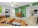 Cozy living space featuring a decorative green paneled wall, an upright piano, and modern tile floors at 4938 W Tuckey Ln, Glendale, AZ 85301