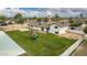 Picture of a large grassy backyard with mature trees and a play structure, great for and outdoor gatherings at 5038 W Acoma Dr, Glendale, AZ 85306