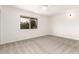 This bedroom is carpeted and has a window that lets in natural light at 5038 W Acoma Dr, Glendale, AZ 85306