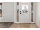 Bright entryway featuring a white door, tile flooring, and sidelight windows at 5038 W Acoma Dr, Glendale, AZ 85306