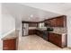 Bright kitchen features stainless steel appliances, granite countertops, and a stylish tile backsplash at 5038 W Acoma Dr, Glendale, AZ 85306