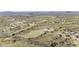 Expansive aerial view shows the property nestled in a vast desert landscape, highlighting the rural community at 50525 W Whirly Bird Rd, Maricopa, AZ 85139