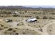 Aerial view of the property with nearby desert scenery and mountain backdrop at 50525 W Whirly Bird Rd, Maricopa, AZ 85139