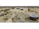 Aerial view showcases the expansive desert landscape of this large property, with multiple structures and a gazebo at 50525 W Whirly Bird Rd, Maricopa, AZ 85139