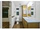 Well-lit bathroom featuring a toilet, built-in storage, mirror, and shower stall at 50525 W Whirly Bird Rd, Maricopa, AZ 85139