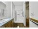 Bright bathroom with a shower stall, vanity with sink, and handrail at 50525 W Whirly Bird Rd, Maricopa, AZ 85139