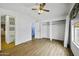 Bedroom with ceiling fan, built in storage, vinyl floors, and natural light at 50525 W Whirly Bird Rd, Maricopa, AZ 85139