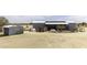 Home featuring solar panels, outbuilding, fenced yard, and natural desert surroundings at 50525 W Whirly Bird Rd, Maricopa, AZ 85139