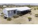 Home featuring inviting porch, and natural desert surroundings at 50525 W Whirly Bird Rd, Maricopa, AZ 85139