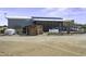 Home featuring solar panels, outdoor utilities, and natural desert surroundings at 50525 W Whirly Bird Rd, Maricopa, AZ 85139