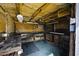 Interior view of the workspace shed, offering exposed beams, pegboard wall, with work bench, and lighting at 50525 W Whirly Bird Rd, Maricopa, AZ 85139