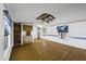 Spacious living area with wood-look floors, ceiling fan, built in features, and natural lighting at 50525 W Whirly Bird Rd, Maricopa, AZ 85139