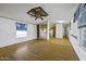 Large living room with open floor plan, ceiling fan, and natural light at 50525 W Whirly Bird Rd, Maricopa, AZ 85139
