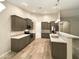The kitchen features sleek gray cabinets, stainless steel appliances, and stylish tile flooring at 5133 S Brice --, Mesa, AZ 85212