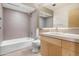 Bathroom featuring a bathtub, toilet, vanity with sink, and tile walls at 525 E Willetta St # 2, Phoenix, AZ 85004