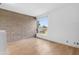 Bright bedroom featuring hardwood floors, block wall and large window with outdoor view at 525 E Willetta St # 2, Phoenix, AZ 85004