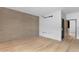 Bright bedroom features hardwood floors, concrete accent wall, and neutral tones, providing a peaceful and contemporary retreat at 525 E Willetta St # 2, Phoenix, AZ 85004