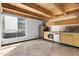 Modern kitchen with stainless steel appliances, wooden cabinets and unique wooden ceiling beams at 525 E Willetta St # 2, Phoenix, AZ 85004