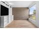 Bright living room featuring hardwood floors, large windows offering plenty of natural light, and a modern concrete accent wall at 525 E Willetta St # 2, Phoenix, AZ 85004