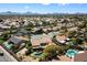 Aerial view features the neighborhood, houses, pools, and mountain views at 5530 E Beck Ln, Scottsdale, AZ 85254
