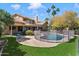 Spacious backyard with pool, patio, green lawn, and mature trees at 5530 E Beck Ln, Scottsdale, AZ 85254